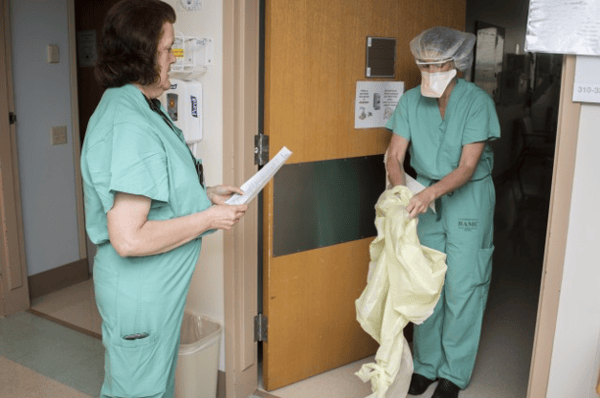 Nurse removing PPE