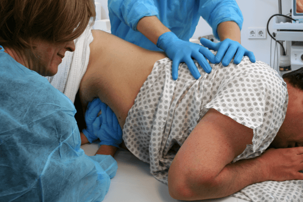 Endoscopy nurse applying abdominal pressure