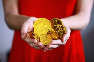 woman holding gold coins